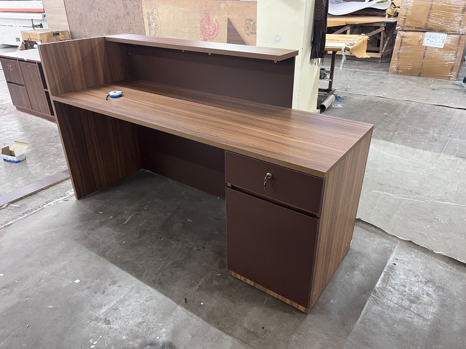 Reception Table Made In Engineered Wood with Matte Grey & King Walnut Laminate and Inlaid Brass Strip Detailing, Built In Storage