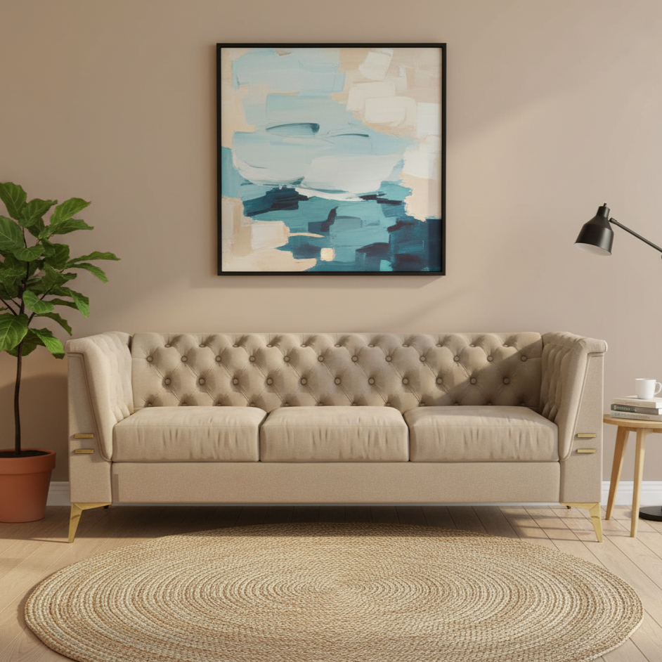 Beige tufted sofa in a living room with abstract art and decor.