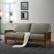 A modern 2-seater sofa with gray upholstery fabric and wooden legs, placed in a well-decorated living room setting.