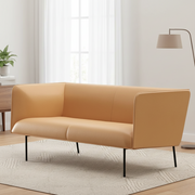 Beige sofa in a modern living room with a lamp and plant.