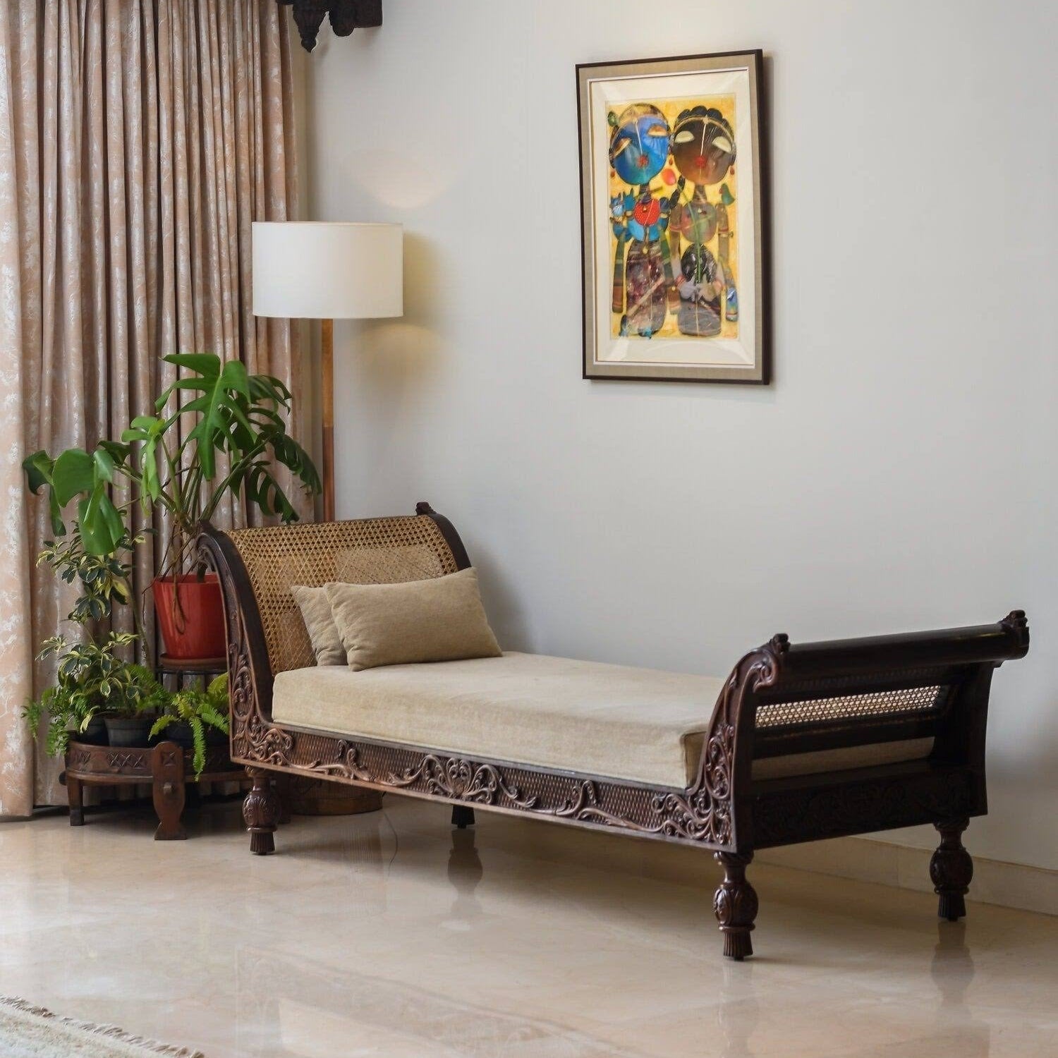 Living room with a wooden sofa, lamp, and decorative wall art.