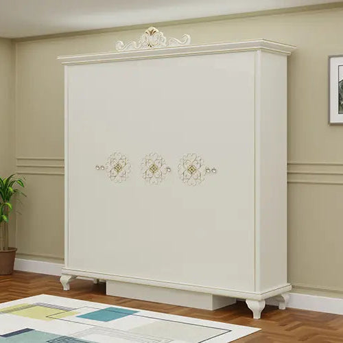 White wardrobe with decorative elements in a room with framed pictures on the wall.