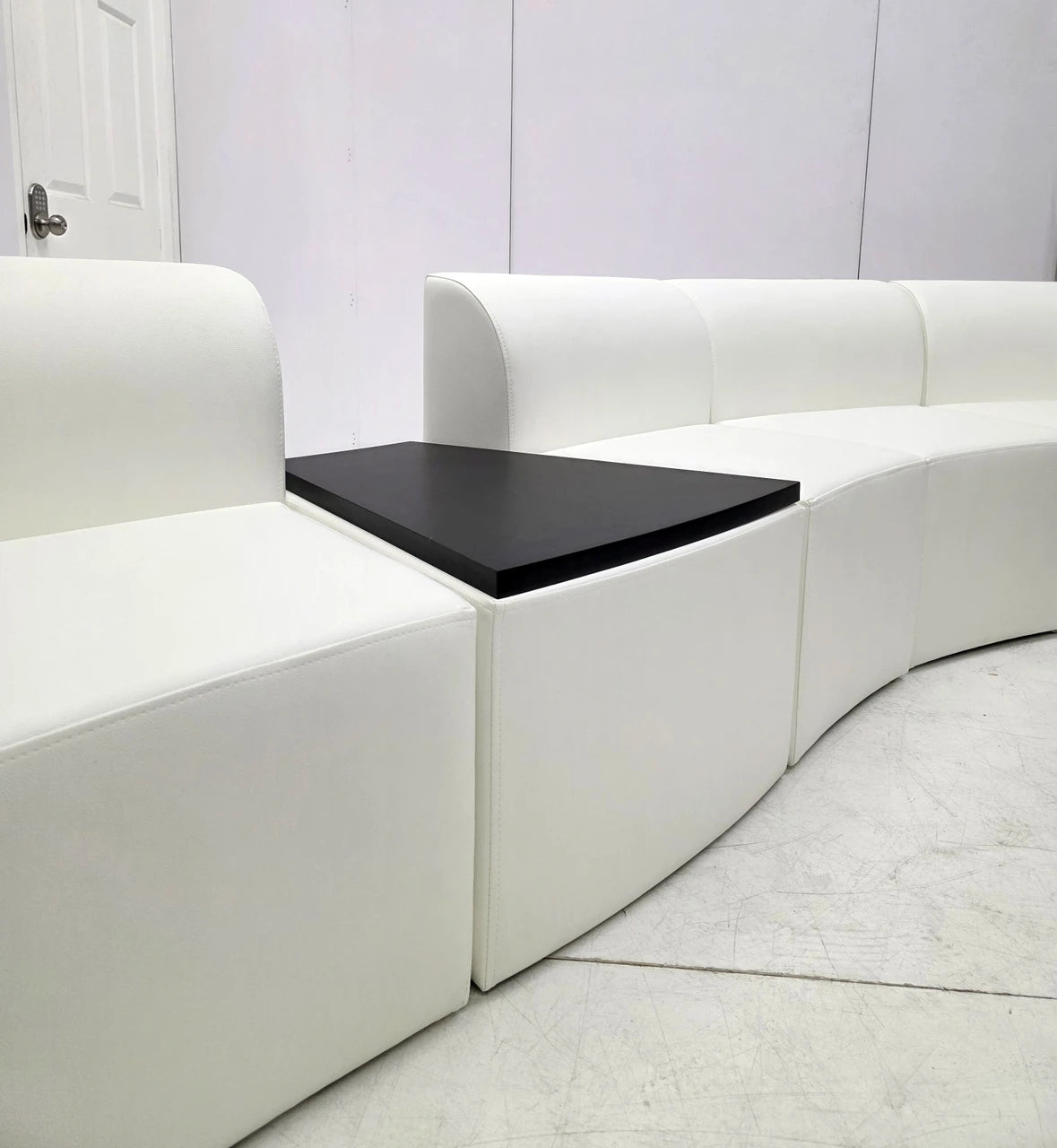 Modular Sectional Sofa with Integrated Wood Wedge Table, Premium Channeled Black Leather Office Lounge Seating, Contemporary Curved Sofa for Lobbies