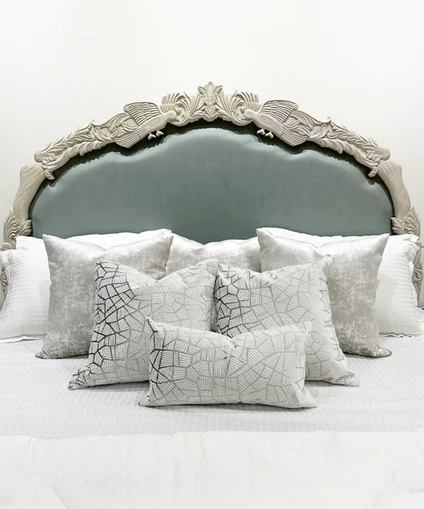 king‑size bed in off‑white with hand-carved Sheesham frame, premium upholstered headboard.
