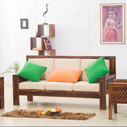 Wicker furniture set with colorful cushions in a living room setting.