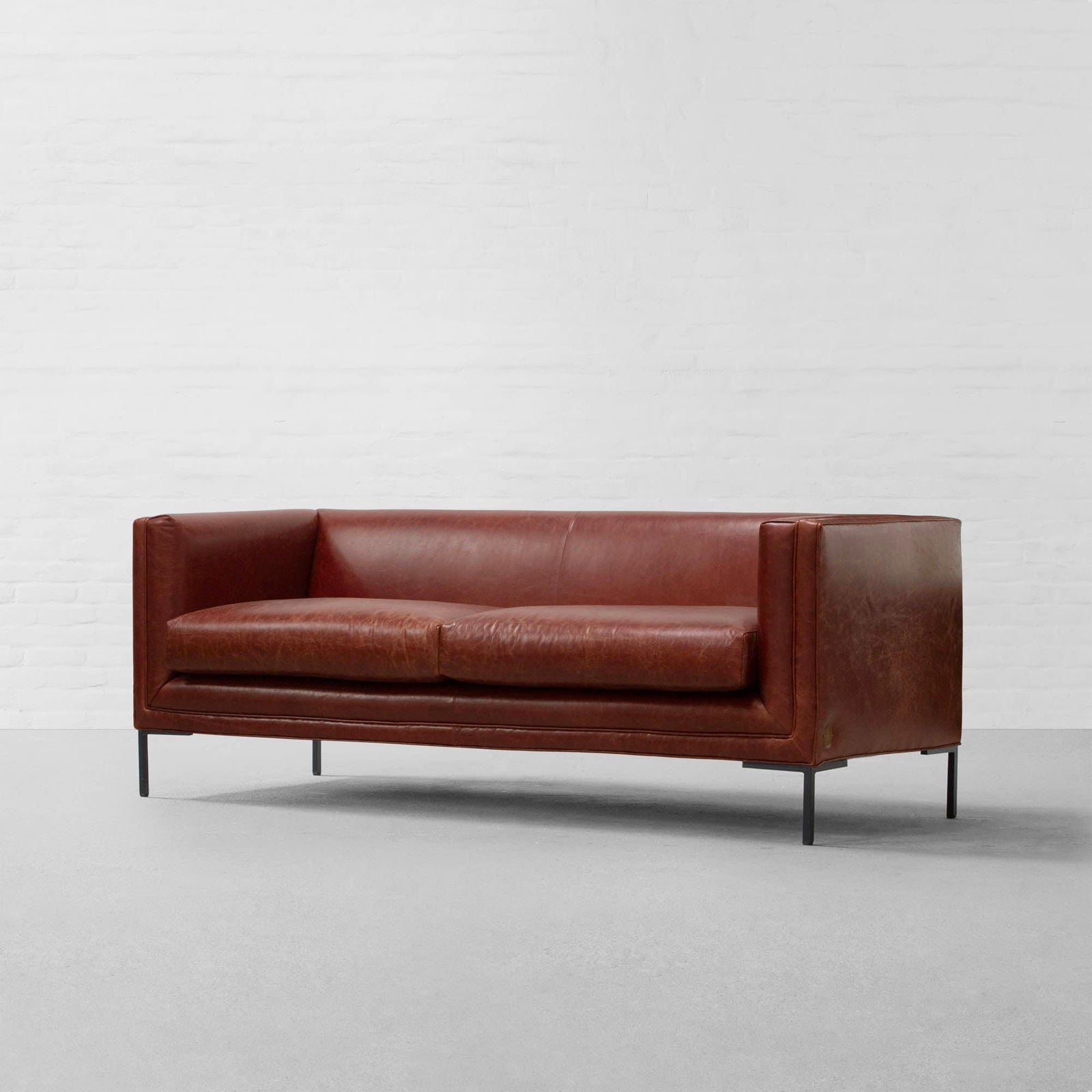4 Seater Brown Sofa in Leatherette  Soft curved corners & slim armrest with Handcrafted Kiln-dried hardwood frame Solid metal legs -