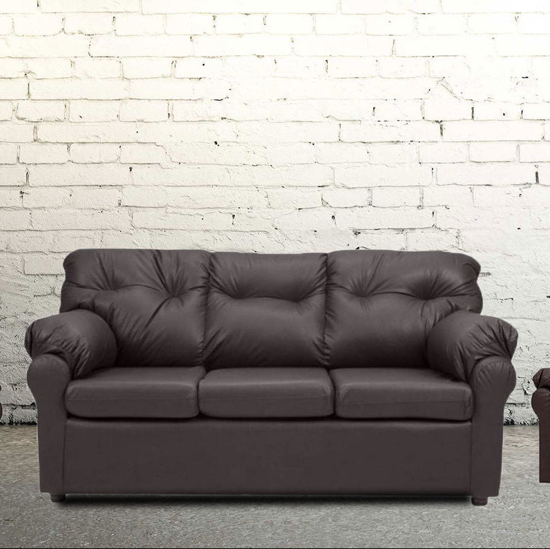 Brown leather sofa against a white brick wall.