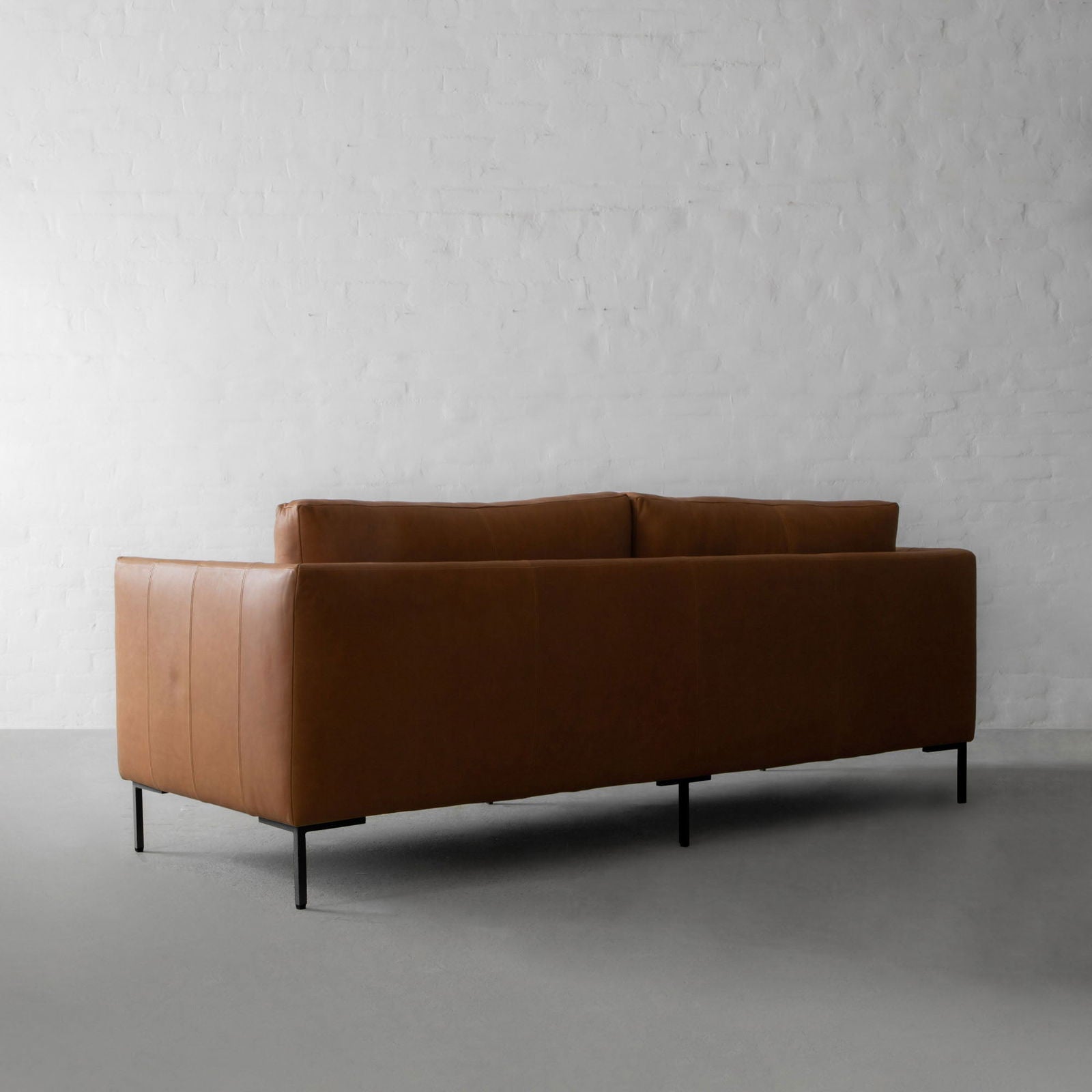 Four Seater Leatherette Sofa with hardwood frame Solid metal legs in black matte finish. -