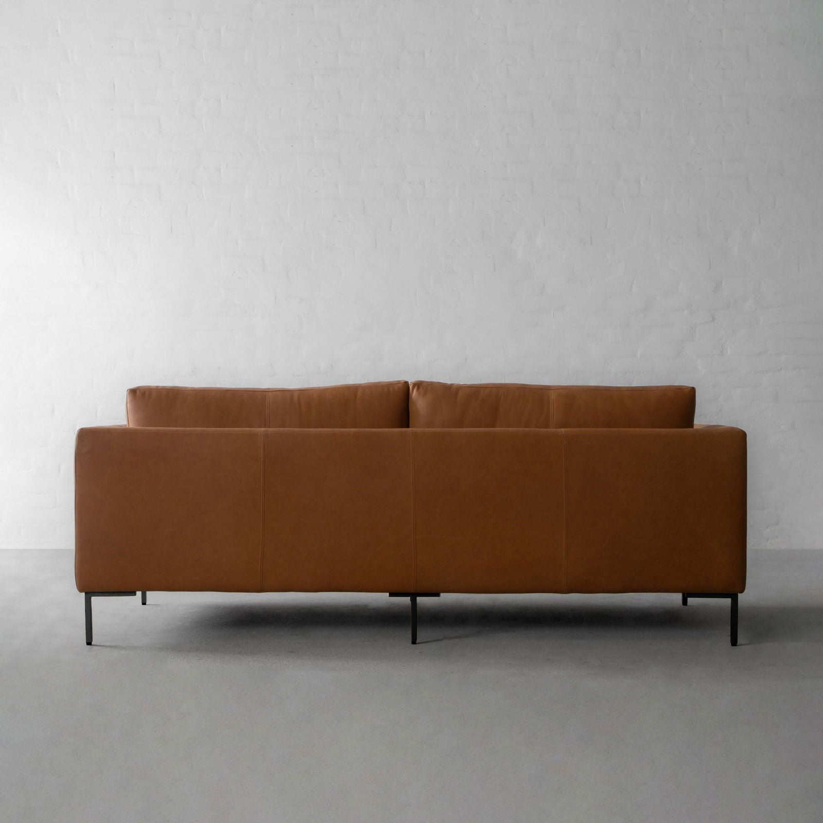 Four Seater Leatherette Sofa with hardwood frame Solid metal legs in black matte finish. -