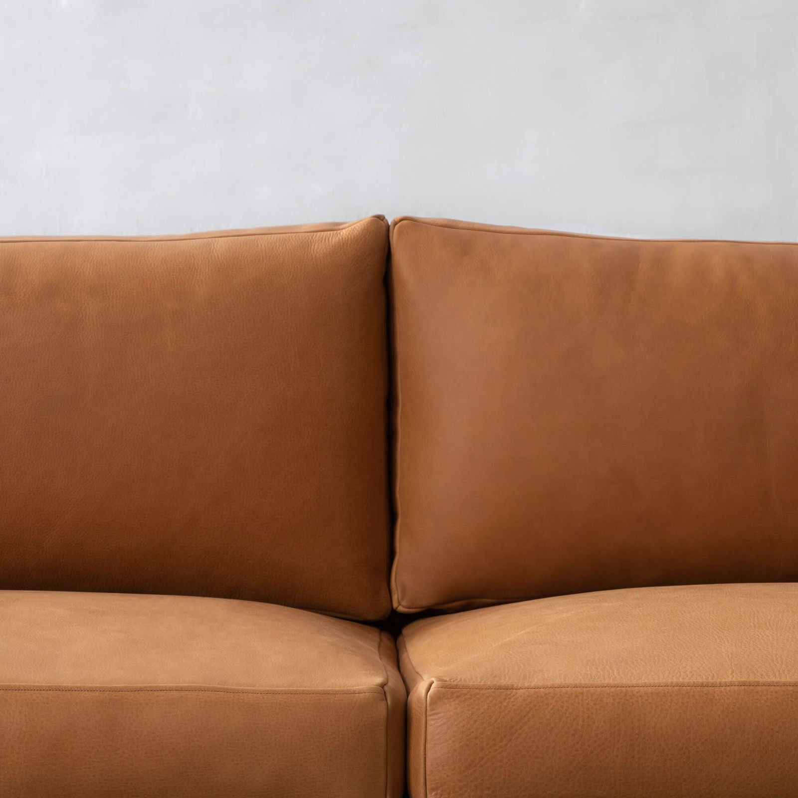 Four Seater Leatherette Sofa with hardwood frame Solid metal legs in black matte finish. -