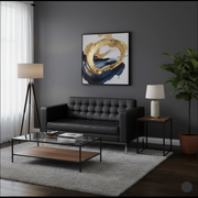 Modern living room with black sofa, glass coffee table, and abstract art on gray wall.