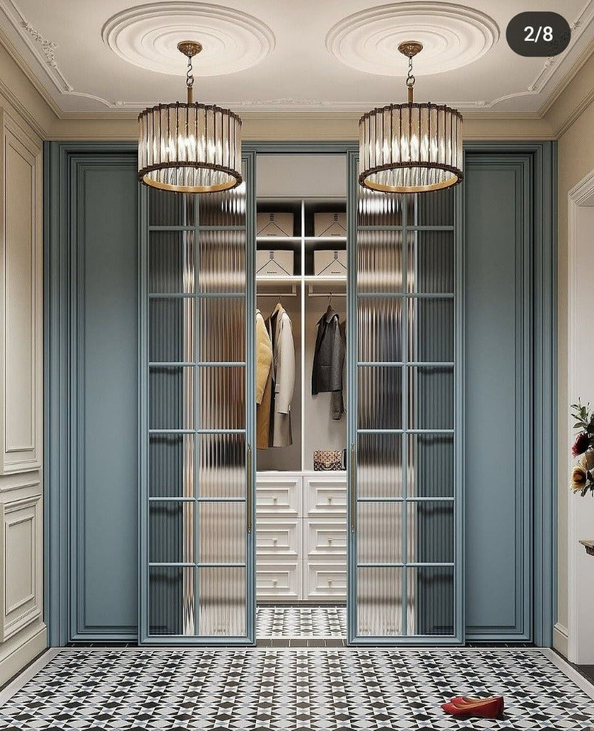 Elegant Dusty Blue Walk-In Closet with Fluted Glass & Brass Trim