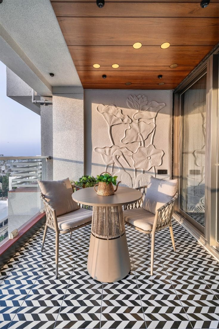 Cozy balcony with geometric flooring, floral wall panel & minimalist seating under a warm wooden ceiling