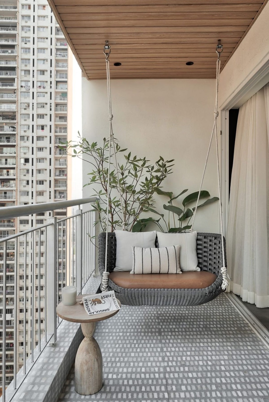 Cozy 5x9 Balcony with Swing, Grey Flooring & Potted Greens