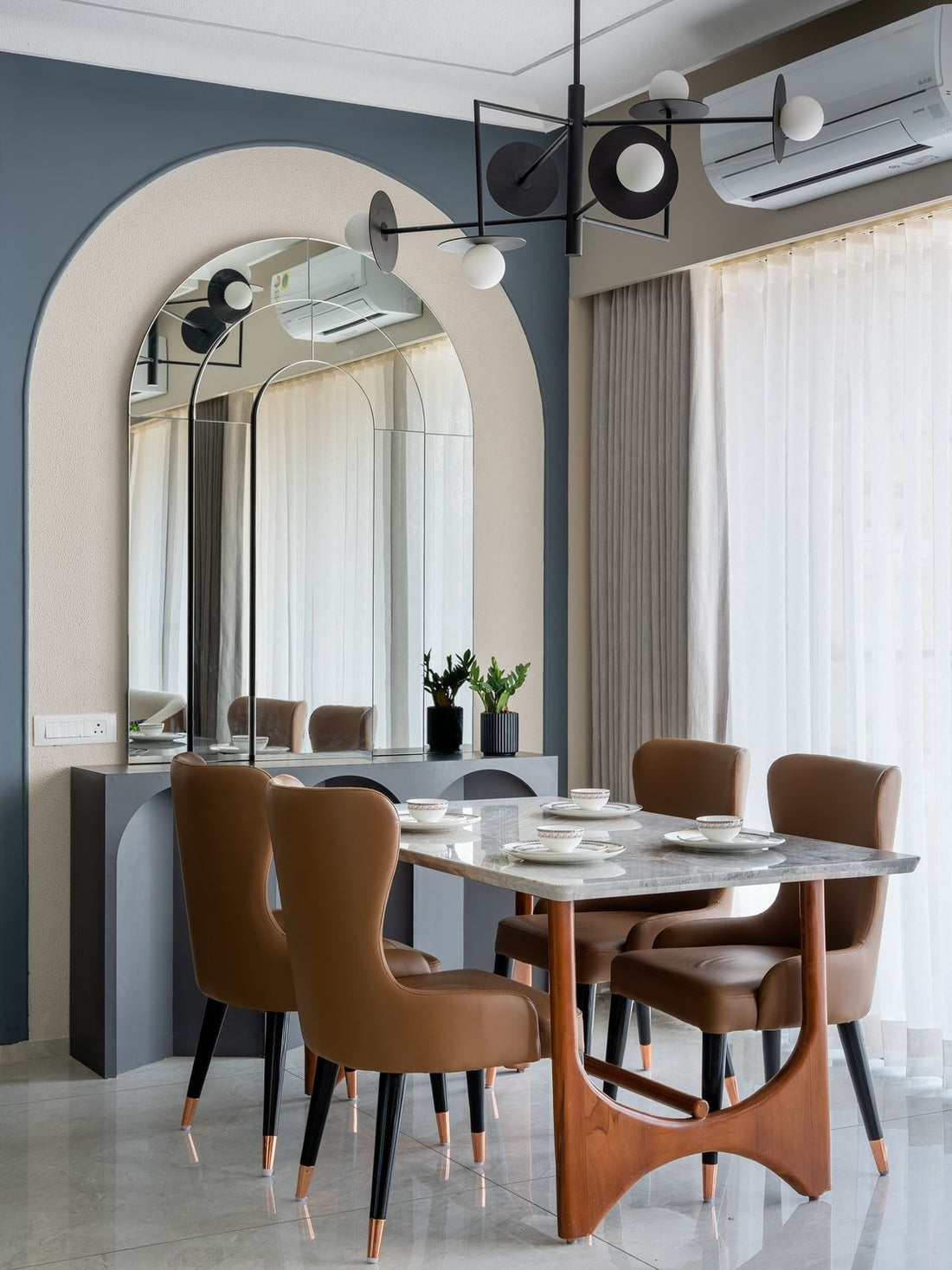 Chic Modern Dining Room – 9ftx 11ft Space with Arched Mirror Wall and Sleek Contemporary Touches
